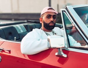 Eladio Carrion sitting in red car